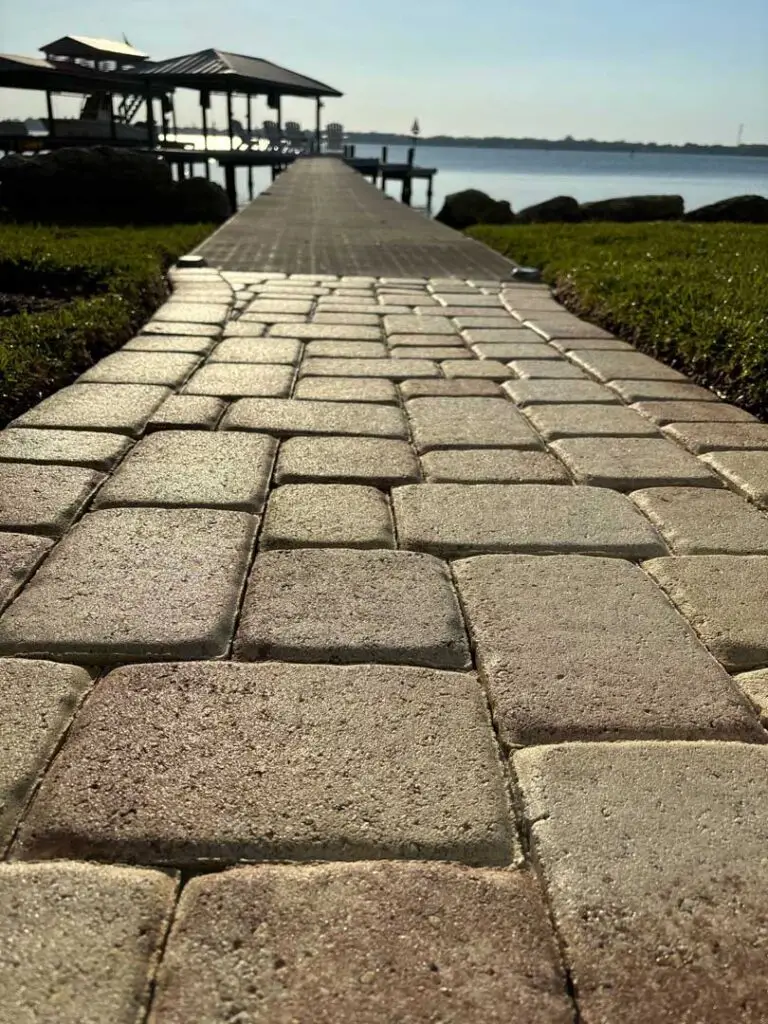 Sealed paver walkway leading to a boat dock.